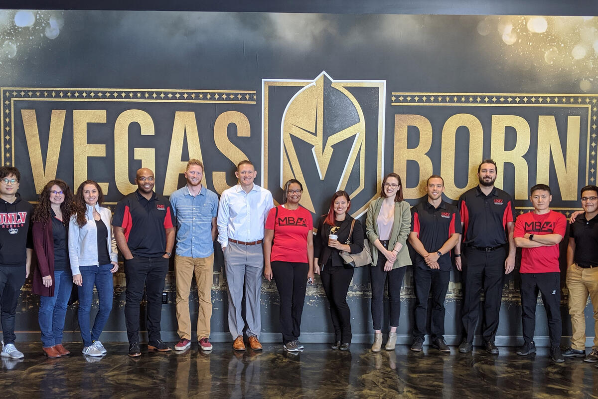 People standing in front of a &quot;Vegas Born&quot; Golden Knights sign
