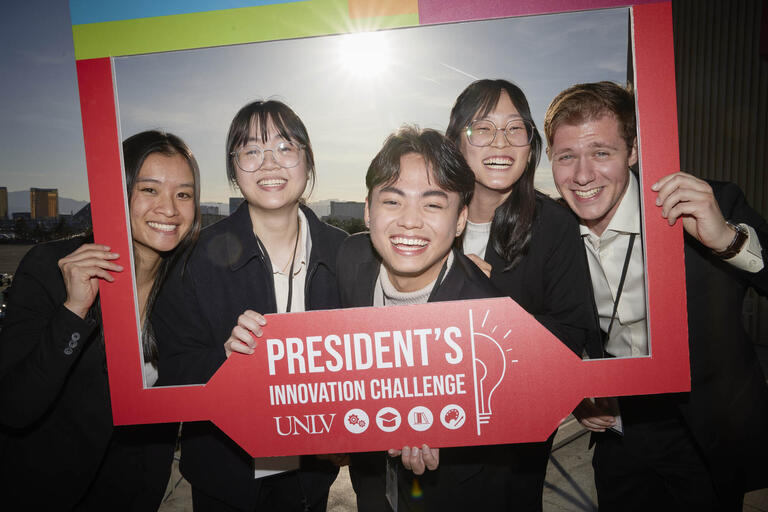 group of students holding a frame that says President's Innovation Challenge